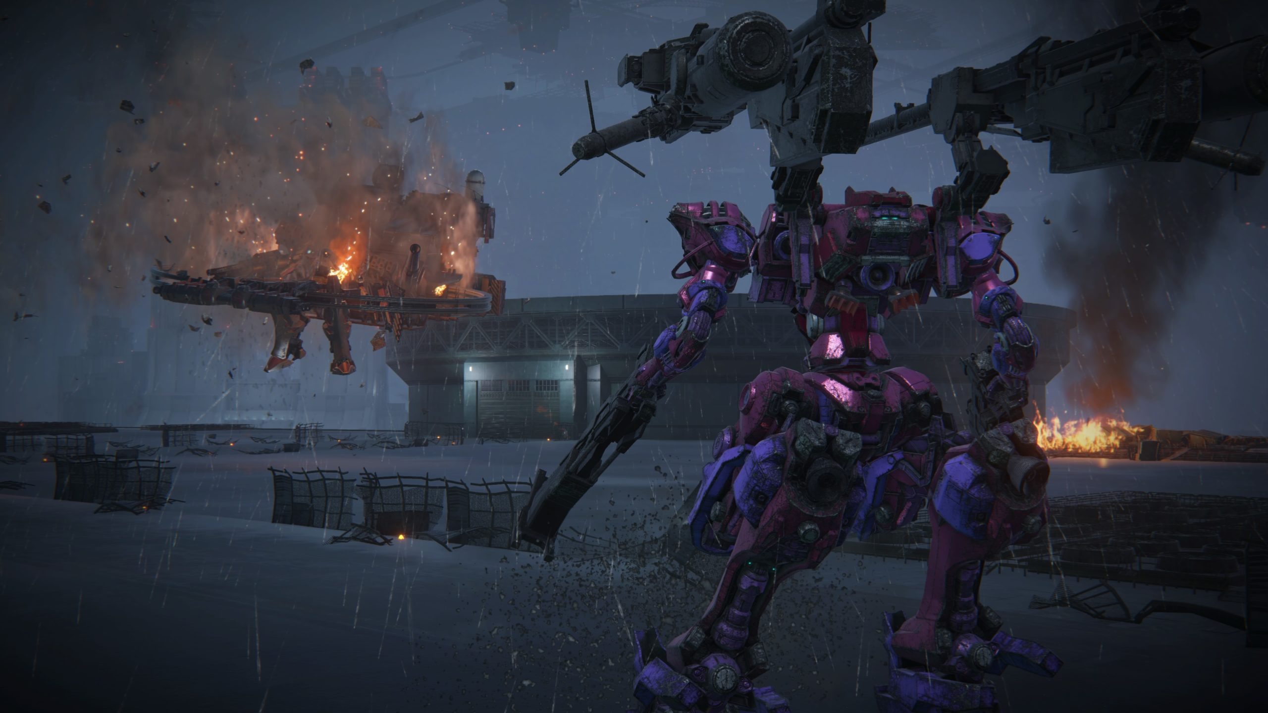 Modo foto em Armored Core VI mostrando o AC após derrotar o chefe Balteus, destruído ao fundo